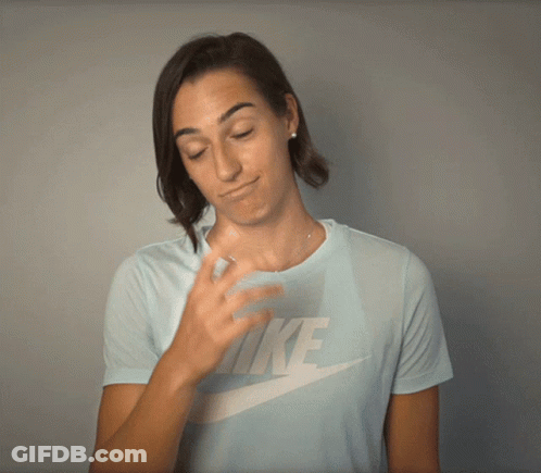 A Woman Wearing A Light Blue Nike Shirt Is Covering Her Face With Her Hand GIF