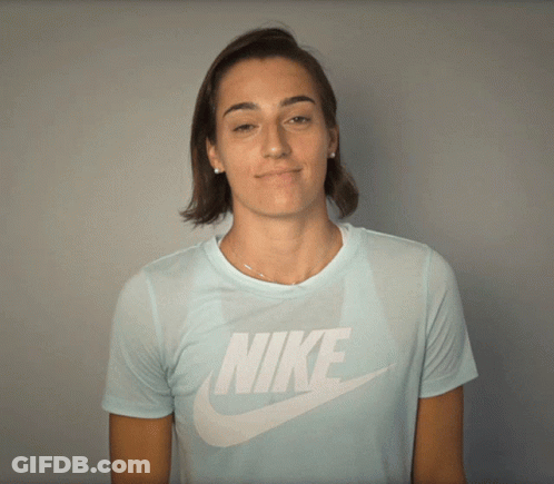 A Woman Wearing A Light Blue Nike T-Shirt GIF