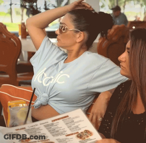 A Woman Wearing A Light Blue T-Shirt That Says Italic GIF