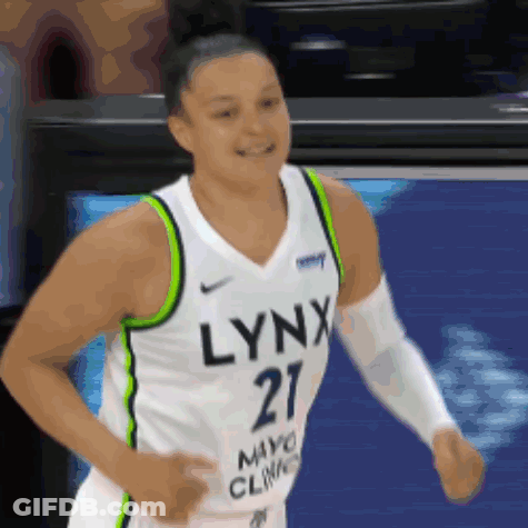 A Woman Wearing A Lynx Jersey Is Running GIF