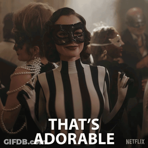 A Woman Wearing A Mask And A Striped Outfit Says That 'S Adorable On The Bottom GIF