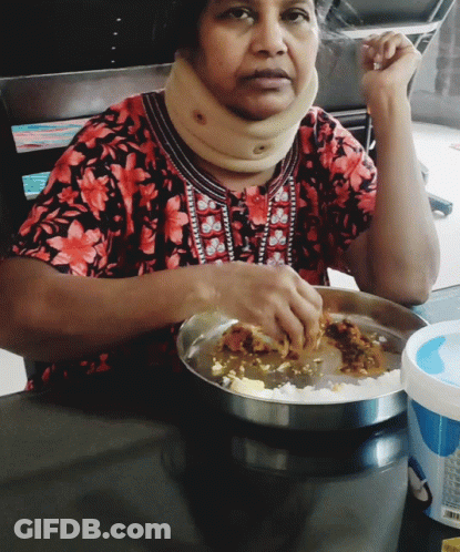 A Woman Wearing A Neck Brace Is Eating Food GIF