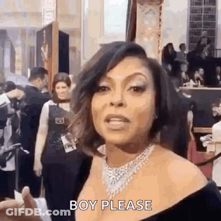 A Woman Wearing A Necklace And A Black Dress Is Standing In Front Of A Crowd . GIF