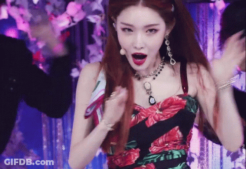 A Woman Wearing A Necklace And Earrings Is Dancing GIF