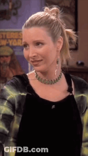 A Woman Wearing A Necklace And Hoop Earrings Stands In Front Of A Poster That Says ' Stones New York ' GIF