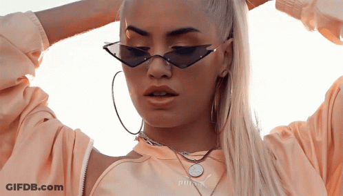 A Woman Wearing A Necklace That Says Puma On It GIF