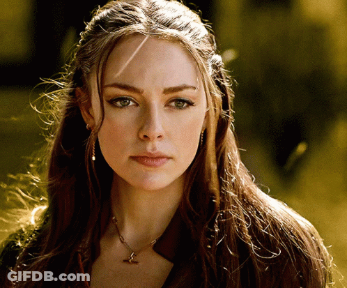 A Woman Wearing A Necklace With A Bird On It GIF