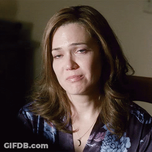 A Woman Wearing A Necklace With A Crescent Moon Pendant Is Crying GIF