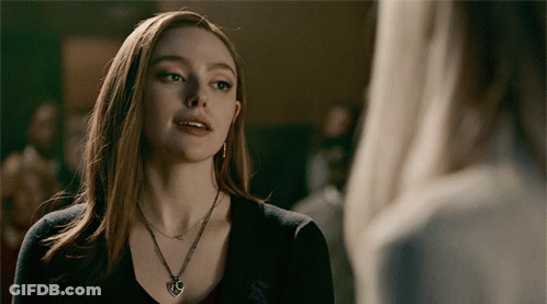 A Woman Wearing A Necklace With A Heart Shaped Pendant GIF