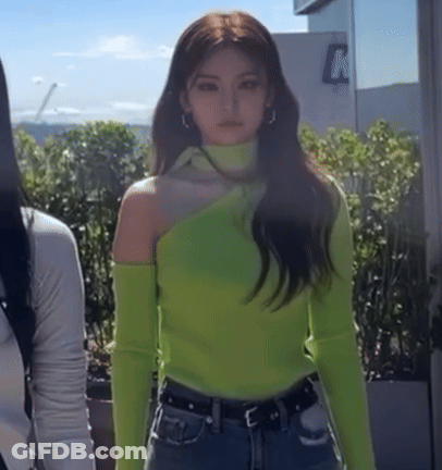 A Woman Wearing A Neon Green Off The Shoulder Sweater GIF