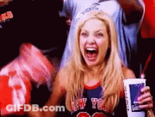A Woman Wearing A New York Jersey Is Holding A Cup Of Soda GIF