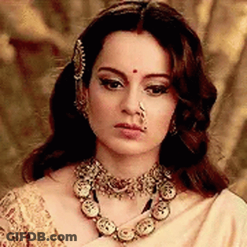 A Woman Wearing A Nose Ring And A Necklace . GIF