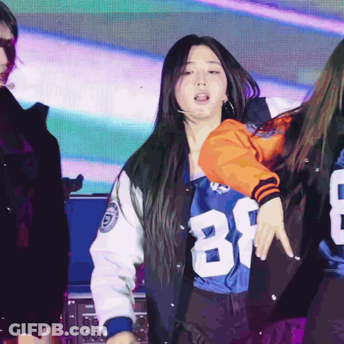 A Woman Wearing A Number 81 Jersey Is Dancing GIF