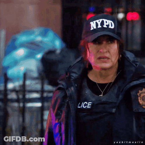 A Woman Wearing A Nypd Hat And A Black Vest GIF