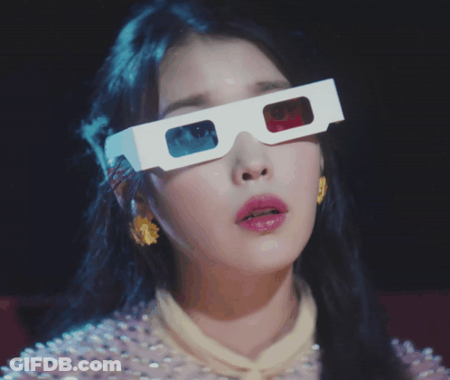 A Woman Wearing A Pair Of 3D Glasses Covering Her Face GIF