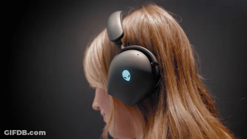 A Woman Wearing A Pair Of Black Headphones With An Alien Logo On Them GIF