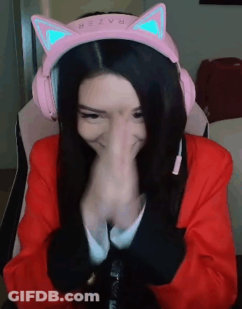 A Woman Wearing A Pair Of Pink Headphones With Cat Ears Is Covering Her Nose . GIF