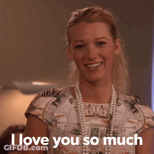 A Woman Wearing A Pearl Necklace And A Floral Shirt Says I Love You So Much GIF