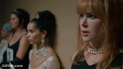A Woman Wearing A Pearl Necklace Stands In A Line With Other Women GIF