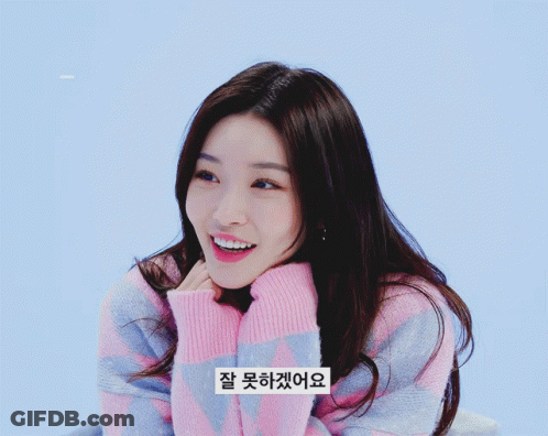 A Woman Wearing A Pink And Blue Striped Sweater Has A Sticker On Her Sweater That Says " 잘 못 하네요 " GIF