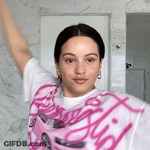 A Woman Wearing A Pink And White Shirt That Says ' Barbie ' GIF