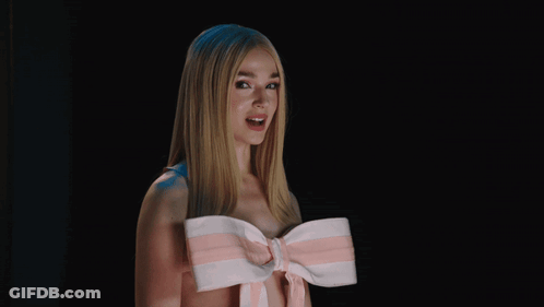 A Woman Wearing A Pink And White Striped Bow Around Her Neck GIF