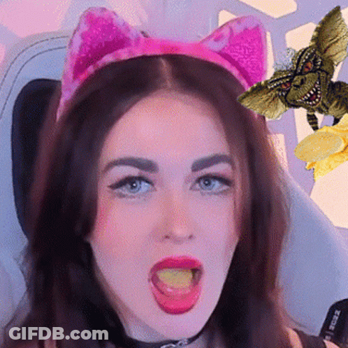 A Woman Wearing A Pink Cat Ear Headband Is Eating A Piece Of Cheese GIF