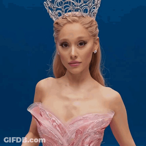 A Woman Wearing A Pink Dress And A Tiara GIF