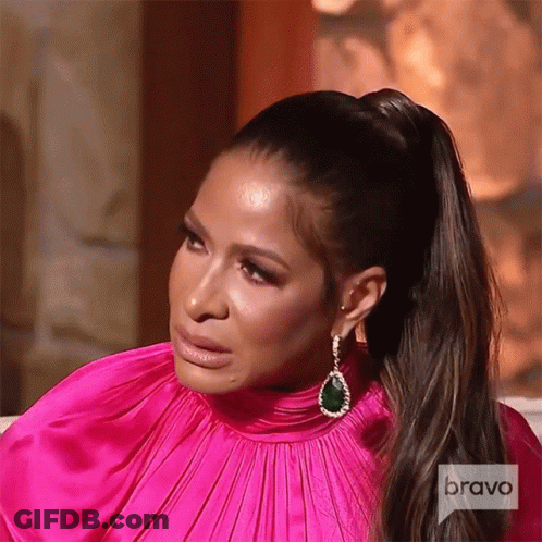 A Woman Wearing A Pink Dress And Earrings Is On Bravo Television GIF