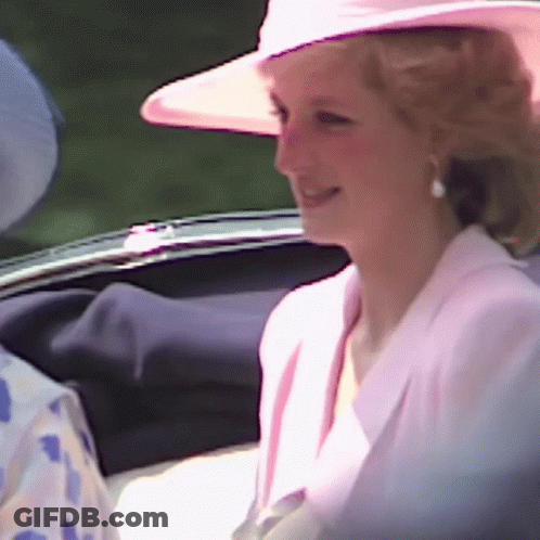 A Woman Wearing A Pink Hat And A White Jacket Is Smiling GIF