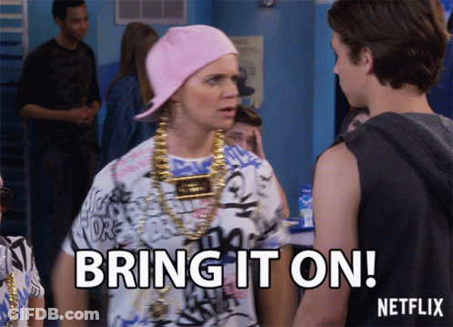 A Woman Wearing A Pink Hat And Gold Chains Says Bring It On Netflix GIF