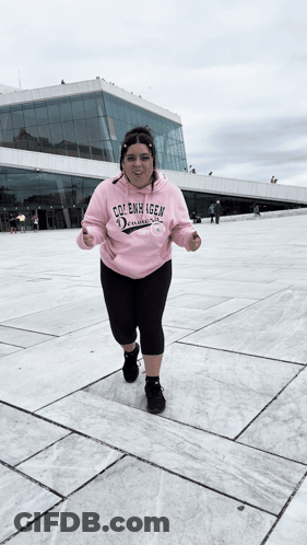 A Woman Wearing A Pink Hoodie That Says Cole Emmy Igen On It GIF