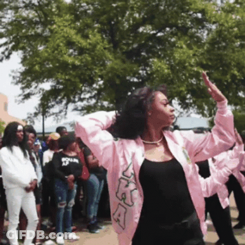A Woman Wearing A Pink Jacket With The Letters Ka On It GIF