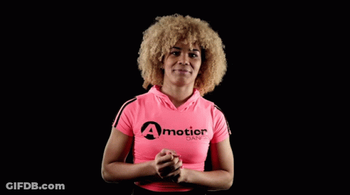 A Woman Wearing A Pink Shirt That Says A Motion Dance On It GIF