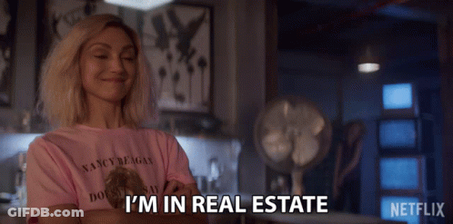 A Woman Wearing A Pink Shirt That Says I 'M In Real Estate On It GIF