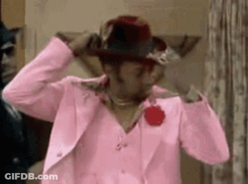 Woman Adjusting Pink Hat And Suit GIF