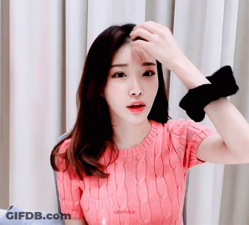 A Woman Wearing A Pink Sweater Has The Word Liufold On Her Shirt GIF