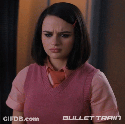 A Woman Wearing A Pink Vest And Tie With Bullet Train Written On The Bottom Right GIF