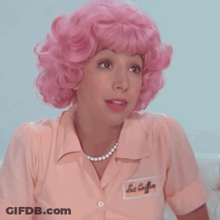 A Woman Wearing A Pink Wig And A Pink Shirt Has A Name Tag On Her Shirt That Says Les Coiffures GIF