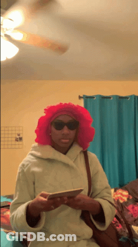 Woman With Pink Wig And Sunglasses Holding Phone GIF