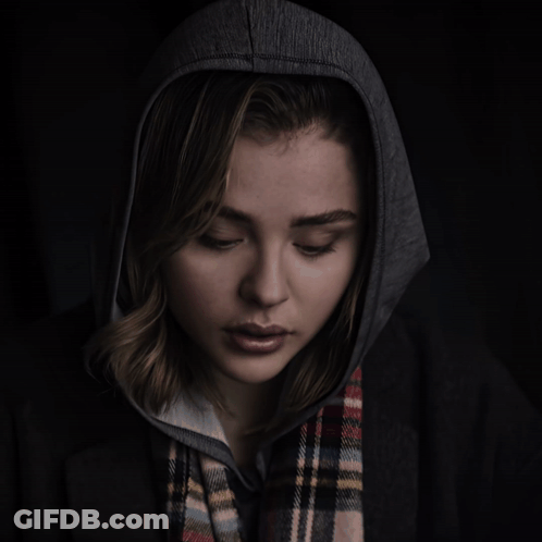 A Woman Wearing A Plaid Scarf And A Hoodie GIF