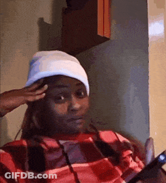 A Woman Wearing A Plaid Shirt And A White Hat Looks At Her Phone GIF