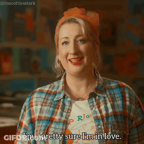 A Woman Wearing A Plaid Shirt And An Orange Headband Says I 'M Pretty Sure I 'M In Love GIF