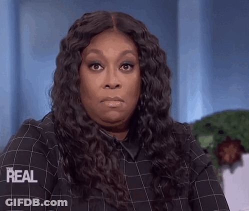 A Woman Wearing A Plaid Shirt That Says Real On The Sleeve GIF