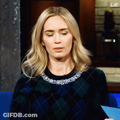 A Woman Wearing A Plaid Sweater Has The Letters Lje On The Bottom Right GIF