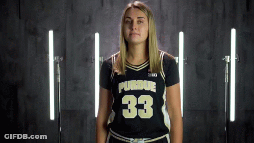 A Woman Wearing A Purdue Jersey With The Number 33 GIF
