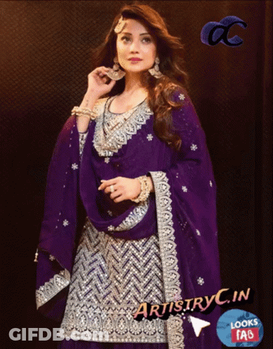 A Woman Wearing A Purple And Silver Dress With Artistry In Looks Faq GIF
