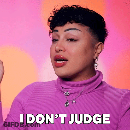 A Woman Wearing A Purple Sweater And Necklace Says I Don 'T Judge GIF