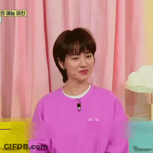 A Woman Wearing A Purple Sweatshirt With A Microphone On Her Neck GIF
