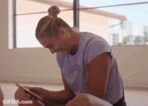 A Woman Wearing A Purple T-Shirt That Says California On It GIF